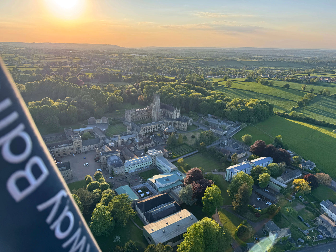 Aerial view of Downside School and surrounding countryside in Somerset from a hot air balloon at sunrise