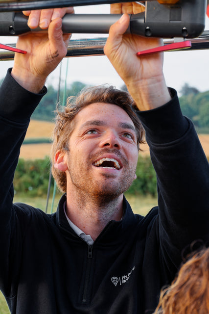 Fly Away Ballooning pilot Hugo Hall smiling and preparing equipment before a hot air balloon flight