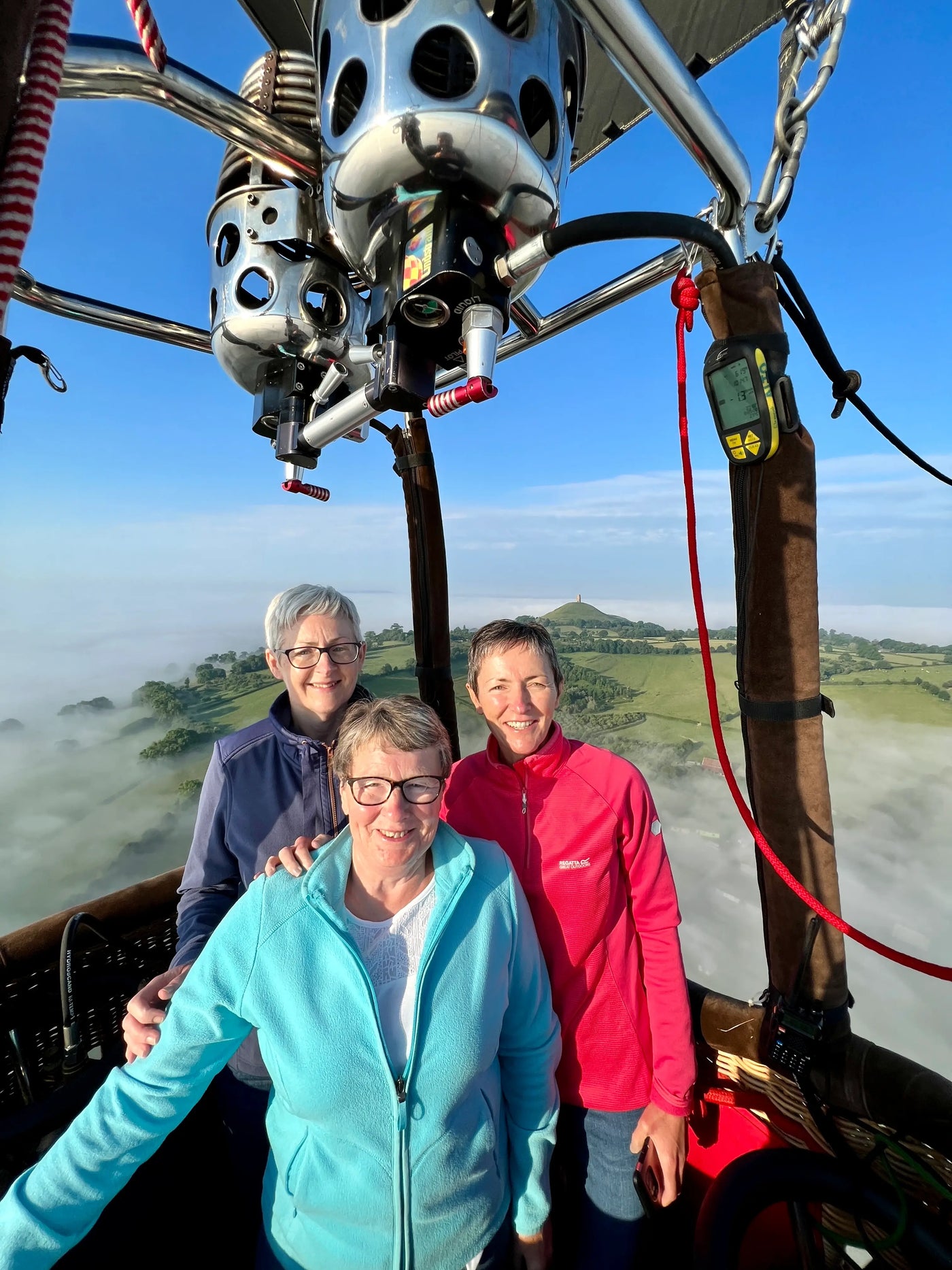 Passengers enjoying a private hot air balloon flight over Glastonbury with Glastonbury Tor in the background