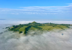 Glastonbury Tor rising above a cloud inversion seen from a hot air balloon flight