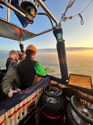 Passengers enjoying sunset views over the Somerset countryside during a hot air balloon flight near Taunton