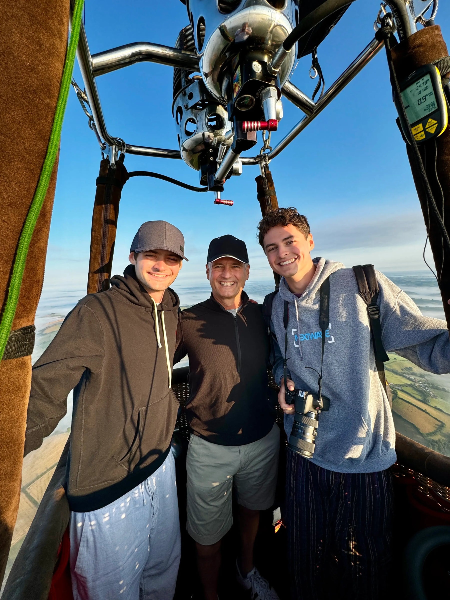 Passengers smiling in a hot air balloon basket during a flight near Tiverton in Devon