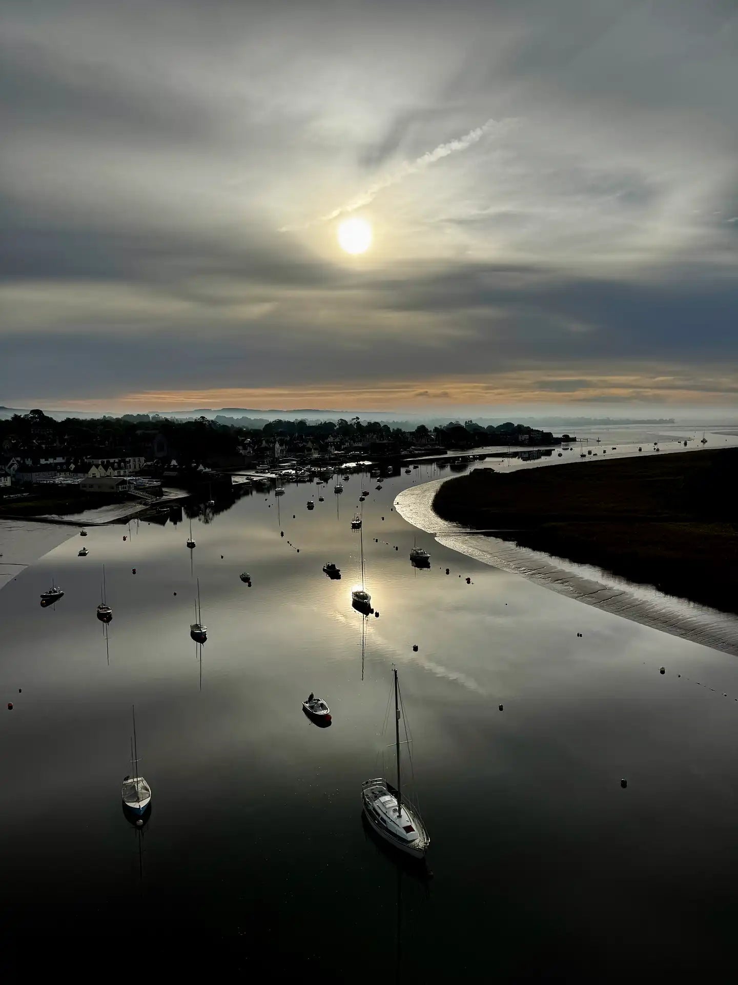Boats on the River Exe estuary at sunrise viewed from a hot air balloon flight near Exeter