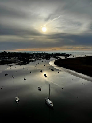 Boats on the River Exe estuary at sunrise viewed from a hot air balloon flight near Exeter