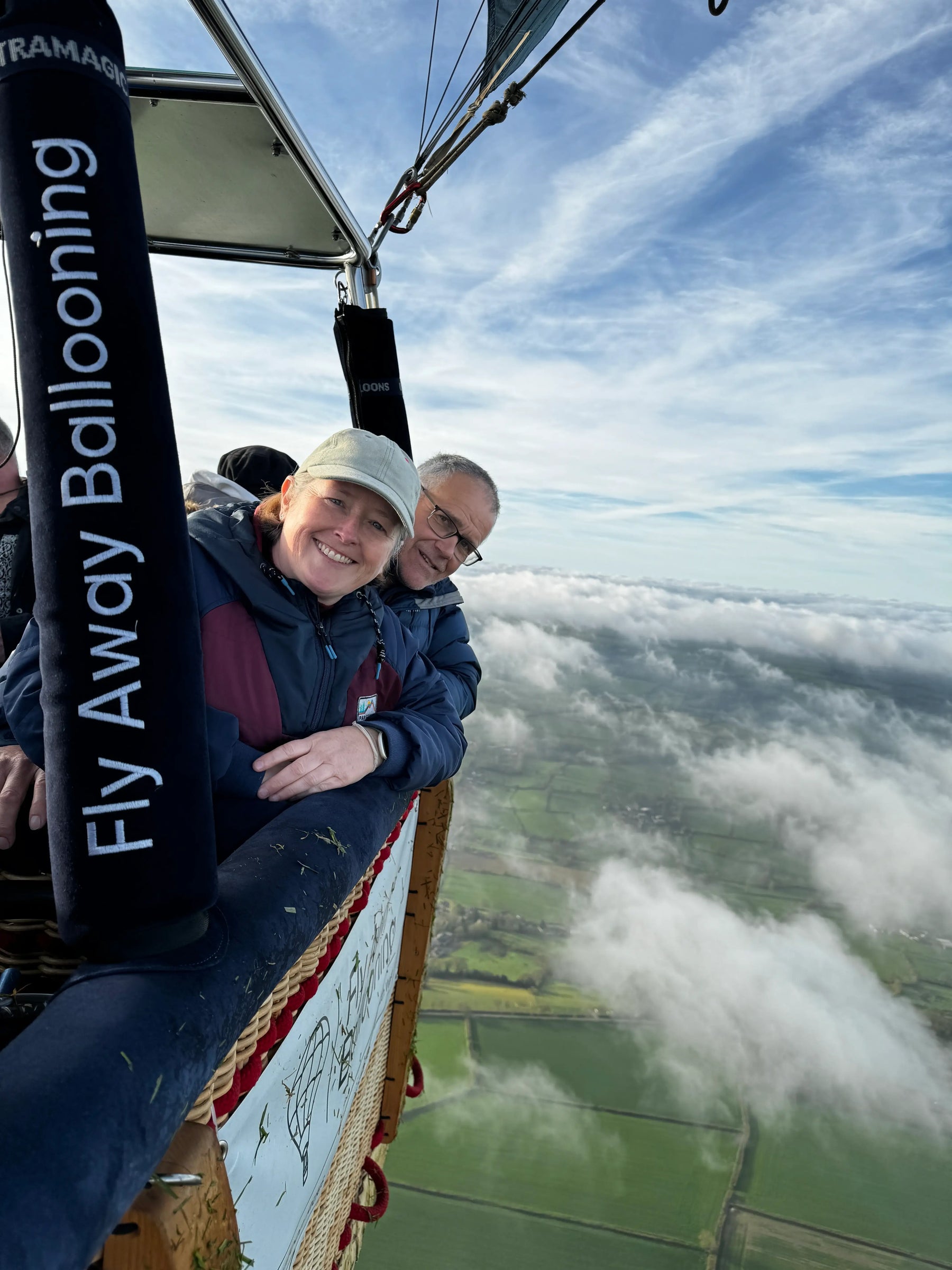 Couple enjoying a hot air balloon flight above clouds near Tiverton in Devon
